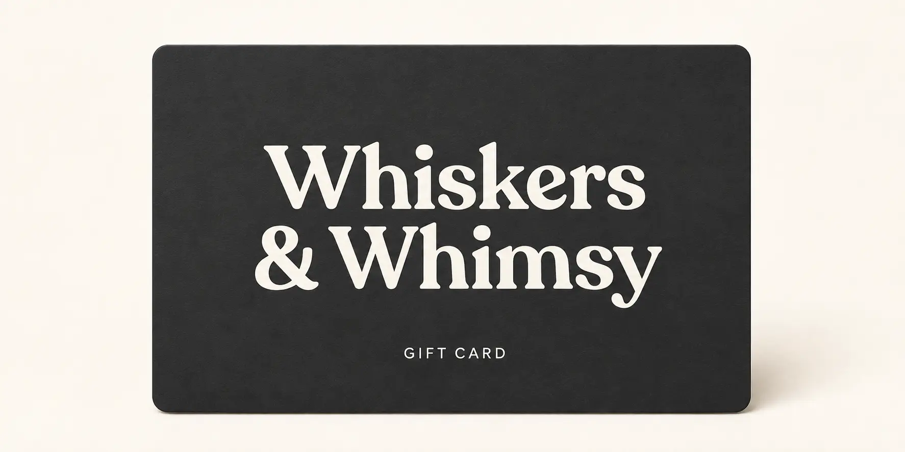 Charcoal Whiskers & Whimsy gift card with a warm ivory wordmark