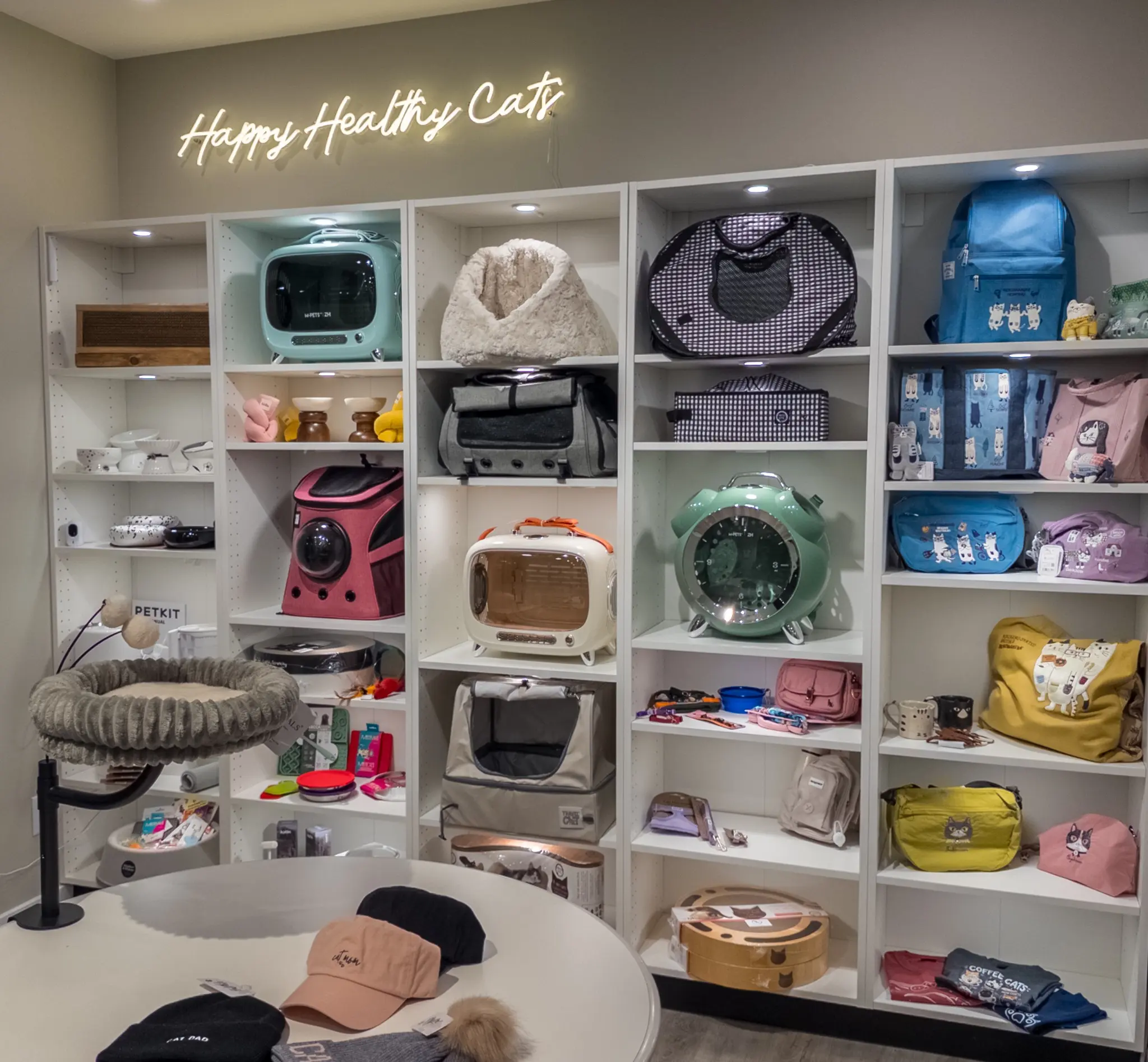 Merchandised Whiskers & Whimsy brand wall with carriers, cat beds, accessories and gifts